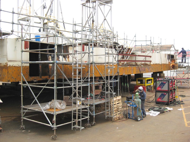 Working scaffolding surrounds the shore side of the pontoon